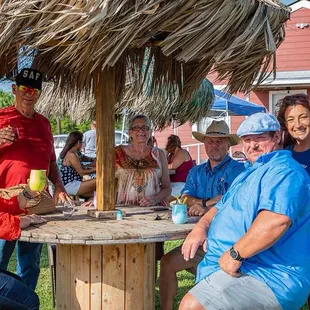 Enjoying the breeze and the palapa tables.