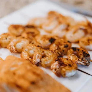 shrimp and shrimp skewers on a white plate