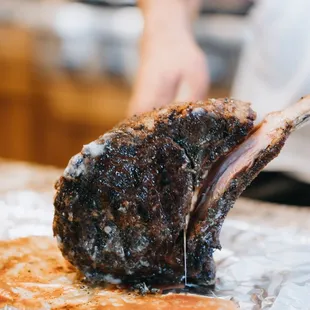 a person cutting a piece of meat