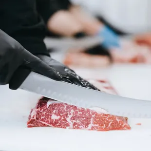 a person cutting a steak