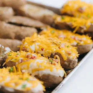 a tray of baked potatoes