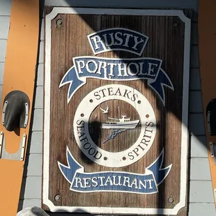 a wooden sign for a restaurant