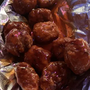 a plate of meatballs covered in sauce