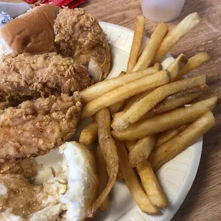 a plate of fried chicken, french fries, and a burger