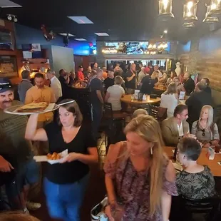 a crowd of people eating and drinking