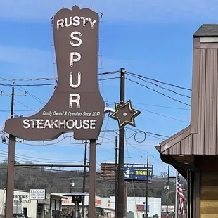 a sign for rusty spur steak house