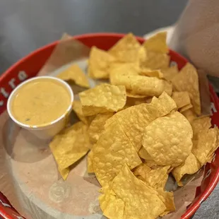 a plate of chips and a bowl of dip