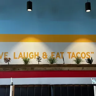 a sign that says love laugh and eat tacos