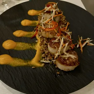 Scallops with a jicama slaw, barley , and a carrot purée.
