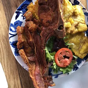 Can Can Pork Chop with tostones. Objects in the picture look smaller than they appear.