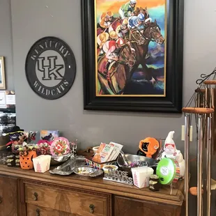 a large painting of horses and jockeys