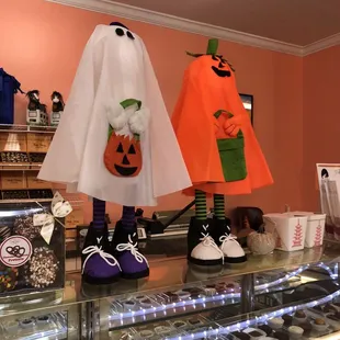 three halloween costumes on display