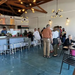 Day 2. Line of people waiting to order. Chatting, happy people.