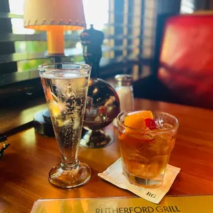 a drink and a menu on a table