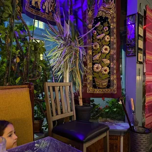 a woman sitting at a table in a restaurant