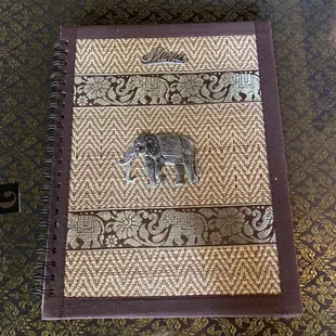 an elephant on a patterned book