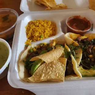 Street tacos with Charo beans and rice. Chips and salsa Verde.