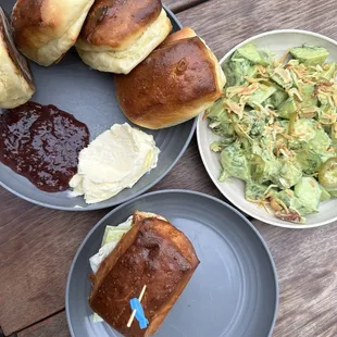 Fish slider, cucumber salad and rolls