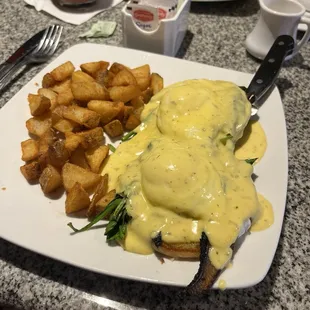 Spinach and mushroom Benedict with hash browns.