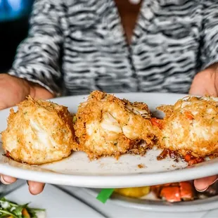 a person holding a plate of food