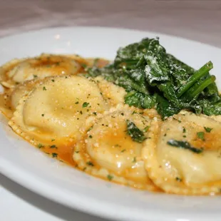 The Veal Osso Buco Ravioli is made with saffron-infused pasta paired with sautéed baby spinach and a veal demi-glace.