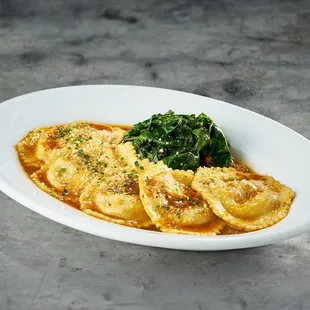 a plate of ravioli with spinach