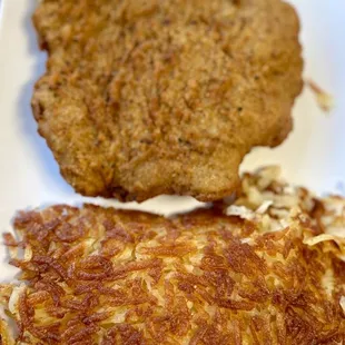 a plate of hash browns and eggs