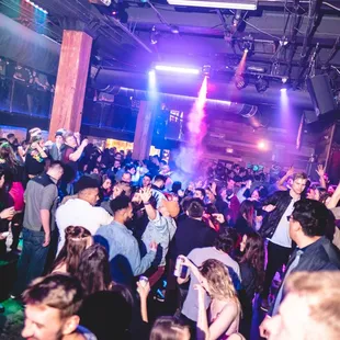 a crowd of people dancing at a party