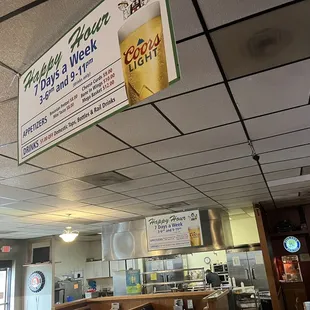 Happy Hour Specials and a view of the kitchen.