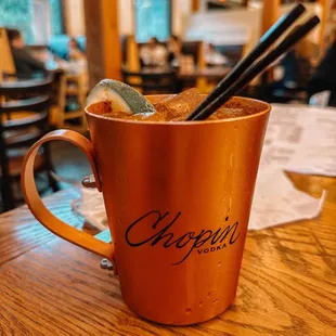 a copper mug with a spoon in it