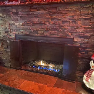 Fireplace can be found at the table near the door.
