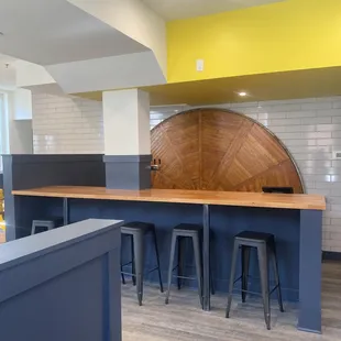 a bar with stools and a counter