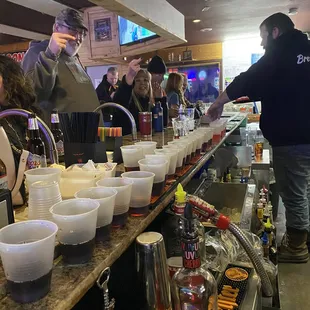 a bartender serving customers at the bar