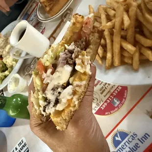 Patty melt with grilled and raw onions, plus add tomatoes and lettuce with a side of regular fries