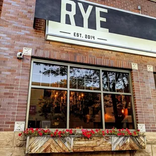 a brick building with a sign above the window