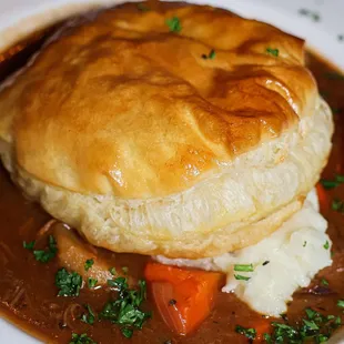 a plate of food with a biscuit on top