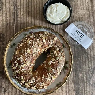 Oat + pepita bagel w/melted leek labneh