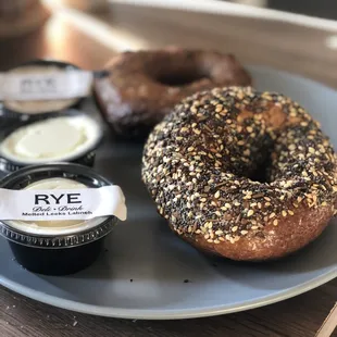 a bagel and butter on a plate