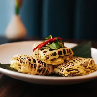 La Tiang 
Shrimp and pork wrapped with egg nest
Serve very refreshing cucumber relish. What a great dish to start your meal.