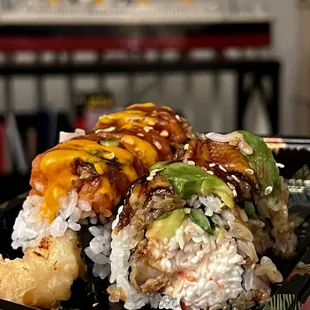 a hand holding a plate of sushi