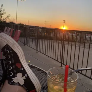 a person's feet and a drink