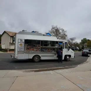 a food truck parked on the side of the road