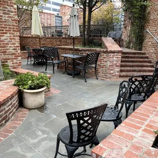 a patio with chairs and tables