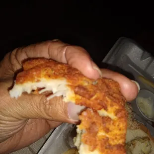 a hand holding a piece of food