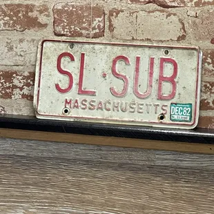 a license plate on a brick wall