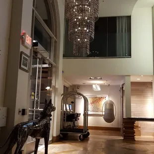 Eyeglass chandelier and utensil dog at the entrance.