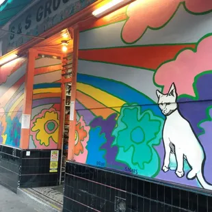 a mural of a cat on the side of a building