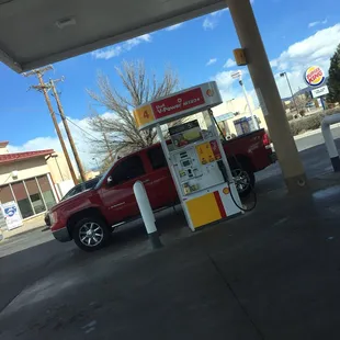 a red truck at a gas station