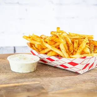  a basket of fries with a side of ketchup