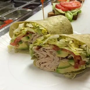 #2 - Avocado Fantasy Sliced turkey breast, avocado, lettuce, tomato, and honey mustard in a spinach wrap.